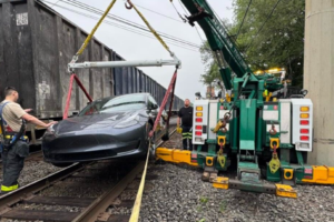 Tesla hit by train lifted crane 3